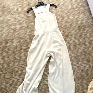 White jumpsuit. Perfect for a bridal shower or rehearsal dinner!